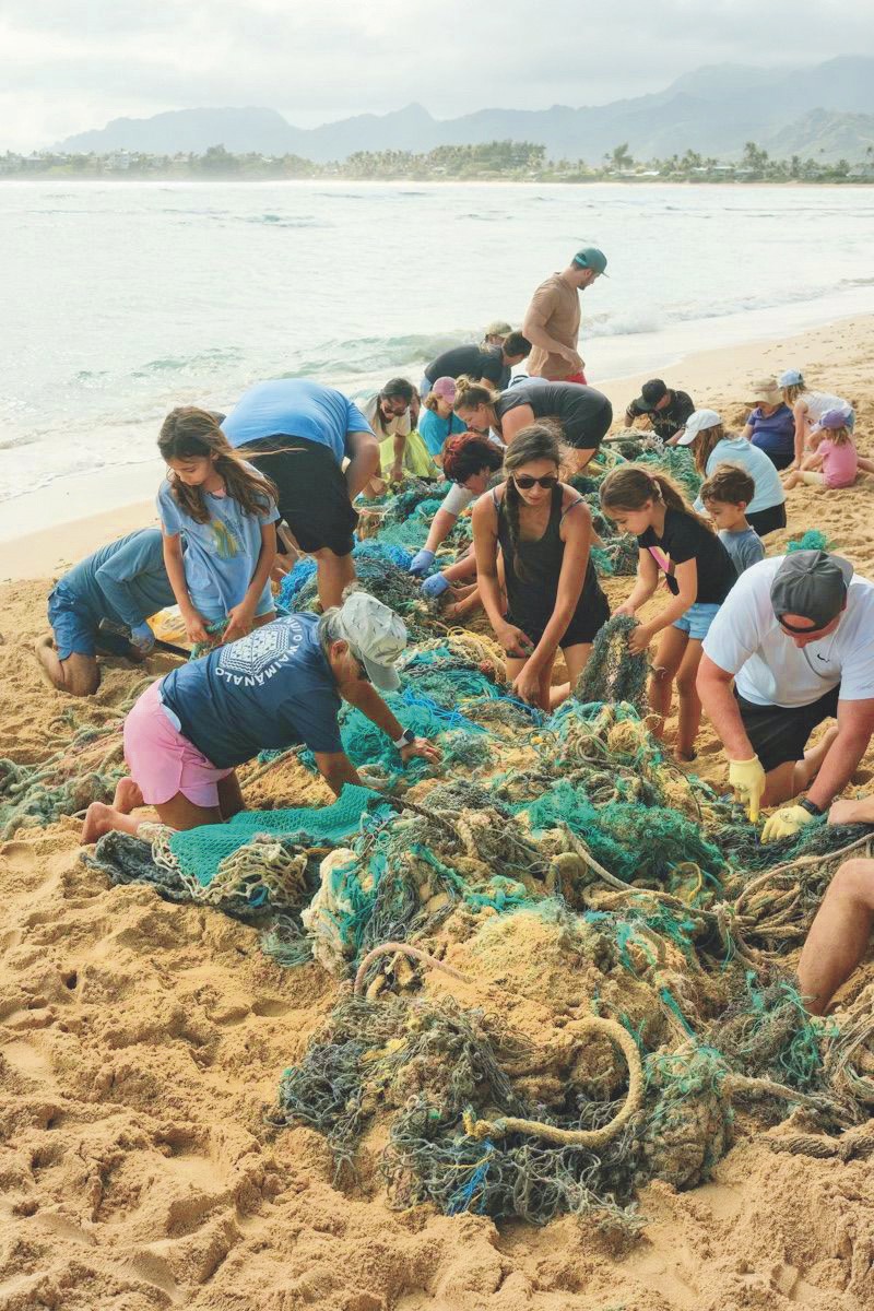 Volunteers removing a ghost net from a Hawai'i beach